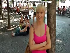 Sexy girl shows tits in the middle of a lively square